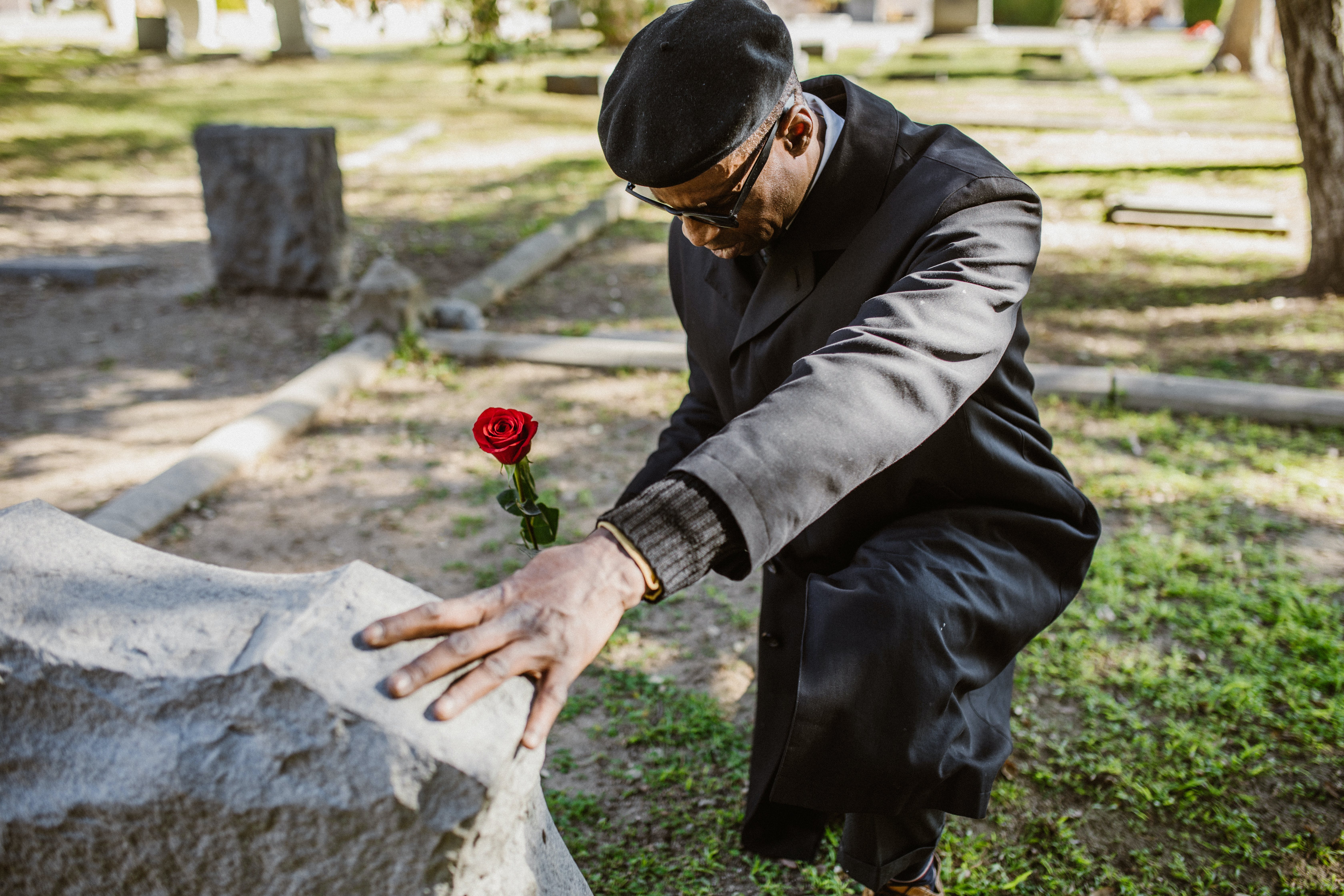 black man mourning at gravesite