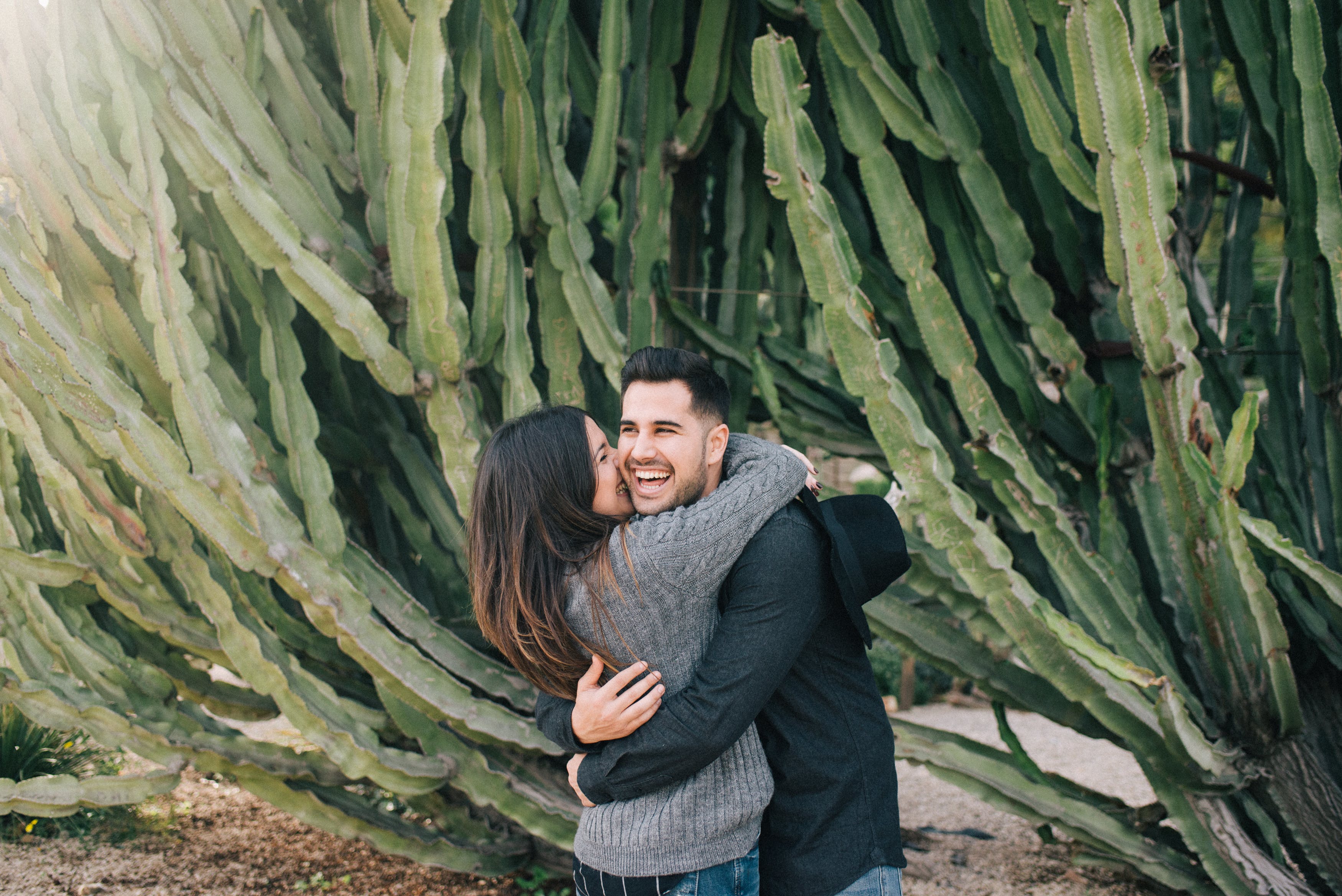 young lovers hugging cactus